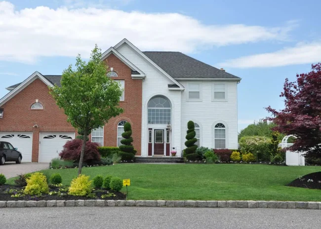 House view from the street Beautifully landscaped suburban home with two car garage. curb appeal